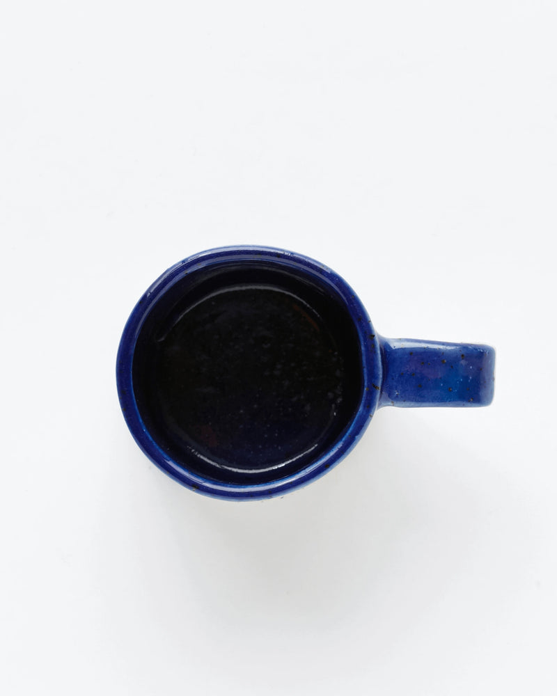 Handmade bright blue ceramic mug top view